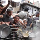 Palestinians struggle to get their food rations outside a crowded distribution centre in Beit Lahia in the northern Gaza Strip on May 15, 2025. Gaza rescuers said Israeli strikes and shelling on Thursday killed 82 people in the war-battered Palestinian territory, updating a previous toll. (Photo by BASHAR TALEB / AFP) (Photo by BASHAR TALEB/AFP via Getty Images)