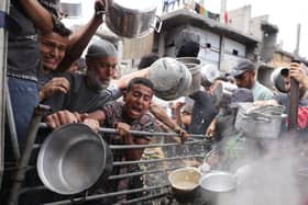 Palestinians struggle to get their food rations outside a crowded distribution centre in Beit Lahia in the northern Gaza Strip on May 15, 2025. Gaza rescuers said Israeli strikes and shelling on Thursday killed 82 people in the war-battered Palestinian territory, updating a previous toll. (Photo by BASHAR TALEB / AFP) (Photo by BASHAR TALEB/AFP via Getty Images)