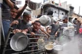Palestinians struggle to get their food rations outside a crowded distribution centre in Beit Lahia in the northern Gaza Strip on May 15, 2025. Gaza rescuers said Israeli strikes and shelling on Thursday killed 82 people in the war-battered Palestinian territory, updating a previous toll. (Photo by BASHAR TALEB / AFP) (Photo by BASHAR TALEB/AFP via Getty Images)