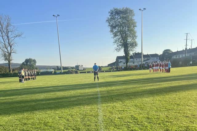 St. Patrick's FC and Killen Rangers U-17s observe a minute's silence for Conor Browne.