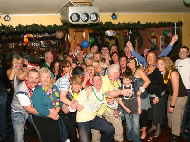 Ann Lindsay calls out i'm in here as she is mobbed by friends and family at her surprise 50th. by the way Ann is in the centre of photo.1206/ dd : Parties in December 2005.
