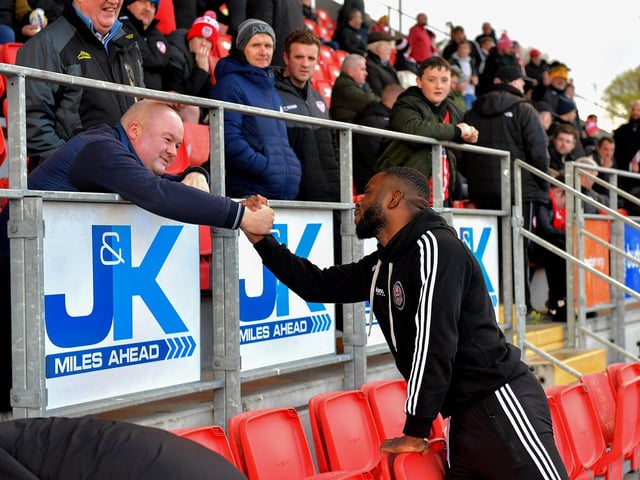 A Derry City fan greets former City striker James Akintunde at the Brandywell on Monday evening. Photo: George Sweeney. DER2315GS – 115