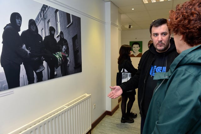 Artist Square Bear chats with a guest at the launch of his exhibition ‘Injustice’ at the Eden Arts Centre on Monday evening last. The exhibition commemorating the 51st anniversary of Bloody Sunday runs until 1st February next.  Photo: George Sweeney. DER2305GS – 75