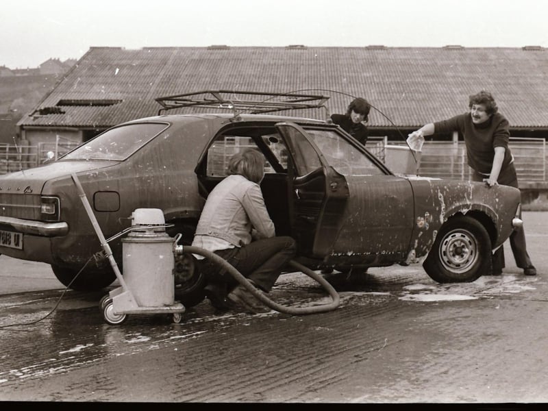 Two of the 15 young men from Long Tower Youth Club who were raising funds for the trip with one of the youth leaders by washing and vaccuming cars for 50p a go to help pay for their trip.