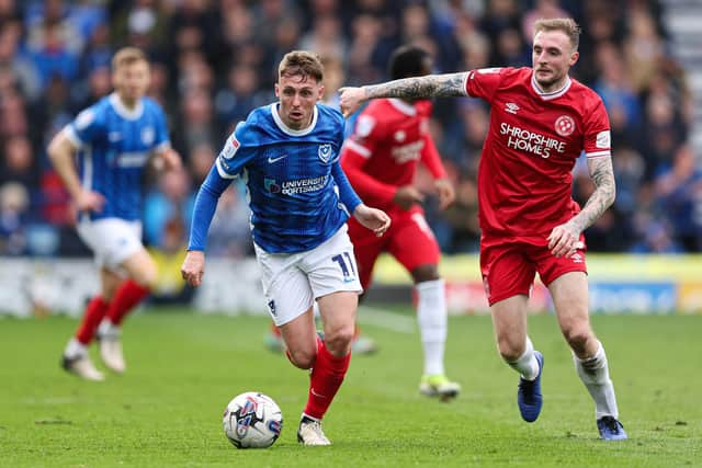 Gavin Whyte (left) and Shrewsbury Town's Carl Winchester (right) battle for the ball.