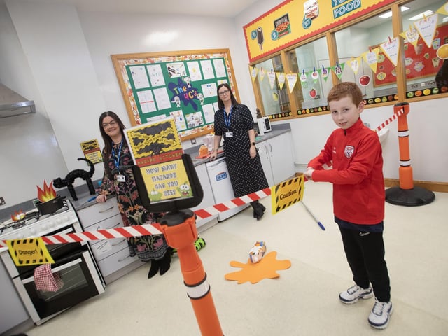 KITCHEN HAZARDS!. . . .Promoting safety in the kitchen at the Home Economics Department on Saturday are teachers Mrs. Blair and Mrs. Browne as Rosemount PS pupil Caoimhin looks on from a safe area. : .
