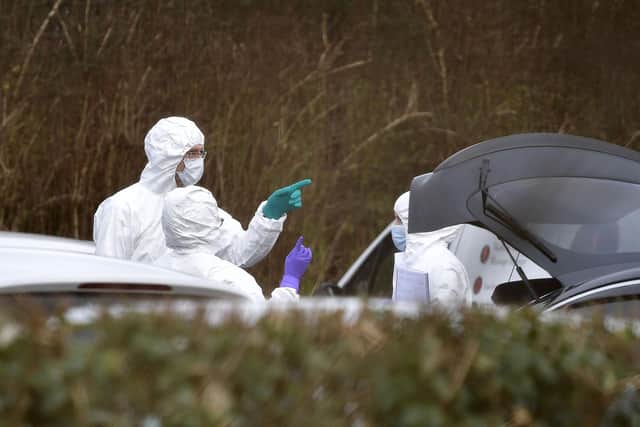 Forensic officers inspect the boot of Detective Chief Inspector John Caldwell's car at the scene of the shooting at the Youth Sports Centre on February 23, 2023 outside Omagh, Northern Ireland. The senior police officer, named as Detective Chief Inspector John Caldwell was shot four times as he put footballs into the boot of his car as he stood along side his son following a football training session. (Photo by Charles McQuillan/Getty Images)