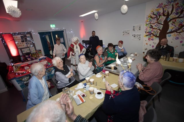Senior citizens join in a sing-song of Christmas carols during last week's party in the Cathedral Youth Club.