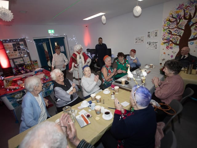 Senior citizens join in a sing-song of Christmas carols during last week's party in the Cathedral Youth Club.