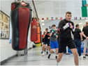 Connor Coyle leads these young boxers in some shadow boxing during a recent training session at St Joseph's ABC.