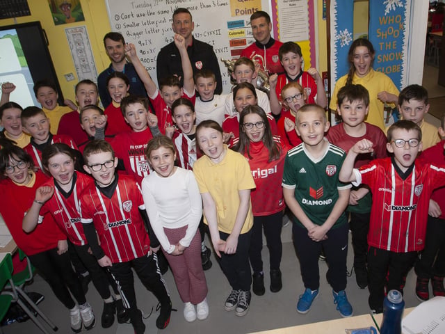 Mr. Hargan and his Primary 7 class welcome Patrick and Shane McEleney to Steelstown Primary School. (Photo: Jim McCafferty)