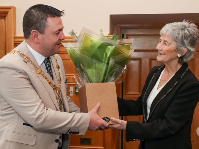Irish President Catherine Connolly receives a bouquet of flowers from the Mayor of Derry and Strabane Councillor Ruairí McHugh. Photo Lorcan Doherty
