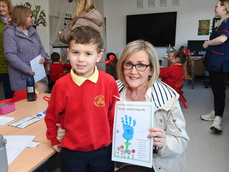 Young Fionn presents his grannd with a gift during her visit to the school last week.