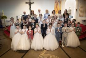 Pupils from Mrs. Ruddy and Mr. Doherty's class at St. Brigid's Primary School who received the Sacrament of First Holy Communion from Fr. Sean O'Donnell at St. Brigid's Church, Carnhill on Friday last. Included are Mr. Mark Doherty, Mrs. Tina Ruddy, teachers, Ms. Mary McCallion, Principal, Mrs. Lorraine Smyth, Ms. Erin O'Reilly and Mrs. Caroline Melaugh, teaching assistants. (Photo: Jim McCafferty Photography)