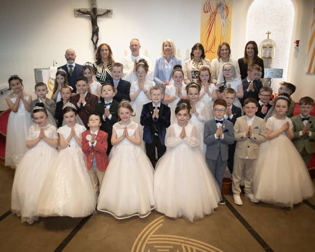 Pupils from Mrs. Ruddy and Mr. Doherty's class at St. Brigid's Primary School who received the Sacrament of First Holy Communion from Fr. Sean O'Donnell at St. Brigid's Church, Carnhill on Friday last. Included are Mr. Mark Doherty, Mrs. Tina Ruddy, teachers, Ms. Mary McCallion, Principal, Mrs. Lorraine Smyth, Ms. Erin O'Reilly and Mrs. Caroline Melaugh, teaching assistants. (Photo: Jim McCafferty Photography)