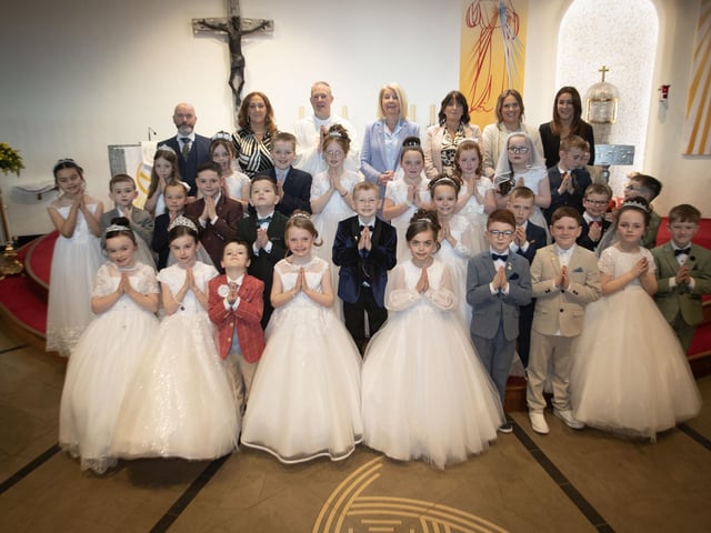 Pupils from Mrs. Ruddy and Mr. Doherty's class at St. Brigid's Primary School who received the Sacrament of First Holy Communion from Fr. Sean O'Donnell at St. Brigid's Church, Carnhill on Friday last. Included are Mr. Mark Doherty, Mrs. Tina Ruddy, teachers, Ms. Mary McCallion, Principal, Mrs. Lorraine Smyth, Ms. Erin O'Reilly and Mrs. Caroline Melaugh, teaching assistants. (Photo: Jim McCafferty Photography)