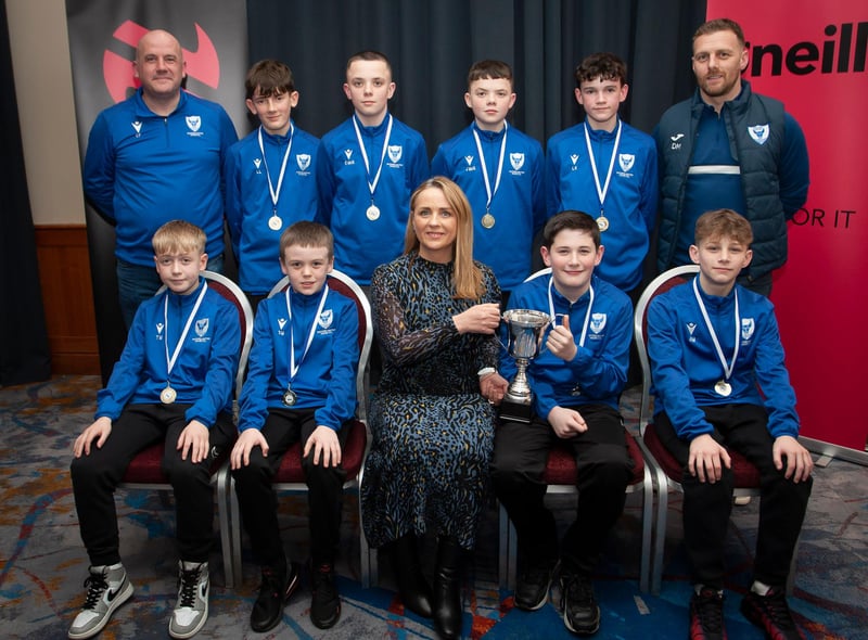 Caroline Casey, manager, O’Neills Sports Superstore, Derry presenting the Winter Cup  to winners Oxford United 2010s at the Annual Awards in the City Hotel on Friday night last. Included are coaches Charlie Ferry and Darren Melly. (Photo:  Jim McCafferty)