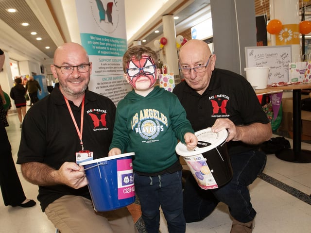 Four years-old Arlo McGuinness donates his pocket money to Paddy McColgan and Joe Carr, ME4Mental Health Support and Suicide Prevention at an event in Lisnagelvin.