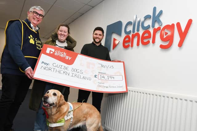 Click Energy staff hand over a cheque of £14,000 to Guide Dogs NI.