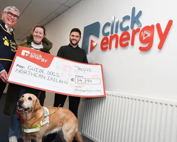 Click Energy staff hand over a cheque of £14,000 to Guide Dogs NI.