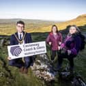 Mayor of Causeway Coast and Glens, Councillor Ciarán McQuillan pictured with Clare Quinn, Council Trade Engagement Officer and Mairéad Whall, Far and Wild at the launch of the 2025 Causeway Coast and Glens Walking Festival.