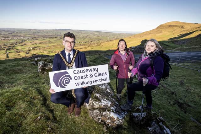 Mayor of Causeway Coast and Glens, Councillor Ciarán McQuillan pictured with Clare Quinn, Council Trade Engagement Officer and Mairéad Whall, Far and Wild at the launch of the 2025 Causeway Coast and Glens Walking Festival.