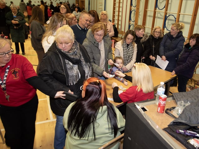 People buying tickets at the Christmas Wheel of Fortune in St. Joseph's Boys' School.