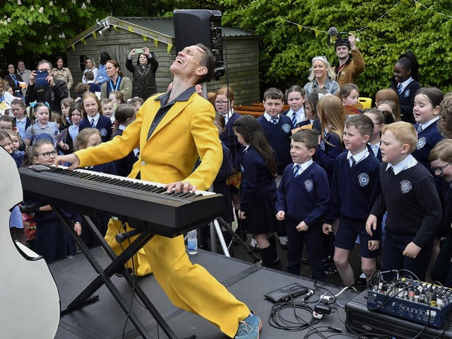 Vince Hurley from the Jive Aces entertaining  pupils from Rosemount Primary School during the band’s visit to the school on Thursday morning. Photo: George Sweeney