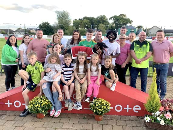 The Old Daly’s Triple Threat 525 at Lifford on Sunday was won by Thats Our Doll in 29.07. Carmel McHugh (4th from left) presents the trophy to joint owner Rachael McCrory. Trainer Niall McGHEE(right). Social media blogger/comedian Fabu D aka Black Paddy is standing at the dog’s head.
