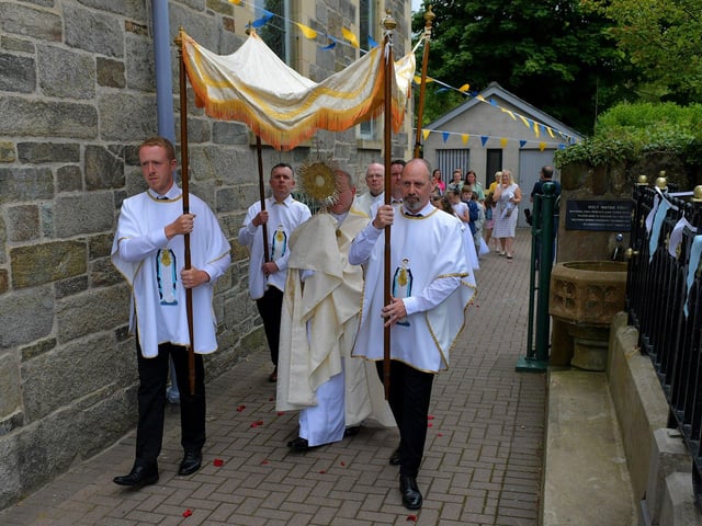Fr. Gerard Mongan, administrator of St Columba’s Church, Long Tower, carries the Blessed Sacrament at the Solemnity of Corpus Christi procession, in the ground of the church on Sunday afternoon. Photo: George Sweeney. DER2324GS –