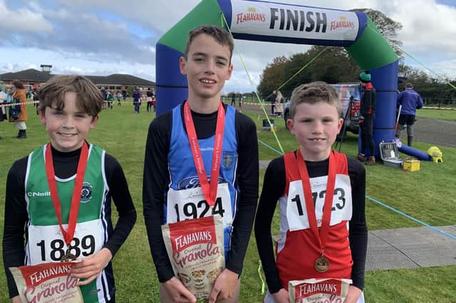 Cillian Morrow (2nd), Paul Devin in (1st)  and Conall Doherty (3rd) at the first round of the 2023-2024 Flahavan’s Athletics NI Primary School Cross Country League which took place at Thornhill College.