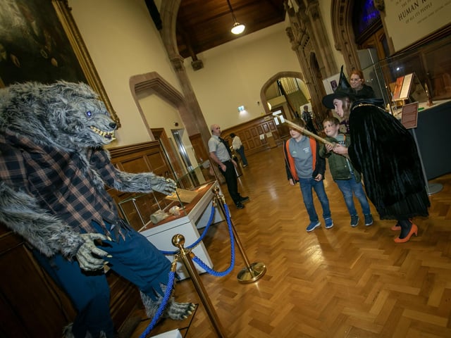 The Mayor, Grace Ui Niallais pictured with two young boys casting a spell on the monster at the Guildhall on Monday.