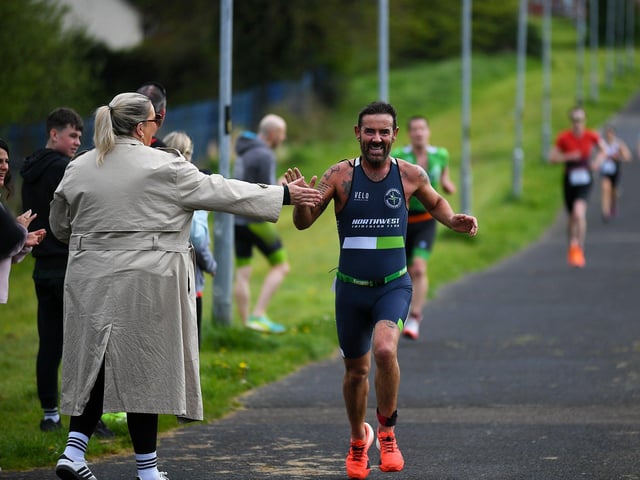 Mickey Doherty greeted by a fan as he finishes the Liam Ball Triathlon on Sunday morning. Photo: George Sweeney