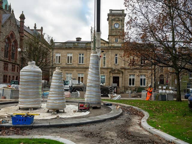 The Factory Girls Sculpture have arrived on site as part of Derry City and Strabane District Councils redevelopment of Harbour Square.. In an operation taking several hours the art work of three spools,  created by Chris Wilson was lowered by crane before being fixed in position. Picture Martin McKeown. 10.12.24