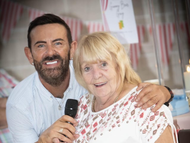 Entertainer Micky Doherty serenades Margaret Kirk from the Shantallow Social Group at Tuesday's DEEDS Tea Party in Creggan. (Photos: Jim McCafferty Photography) : .