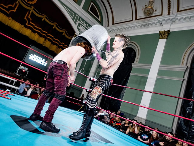 This wrestler gets hit by a bin.