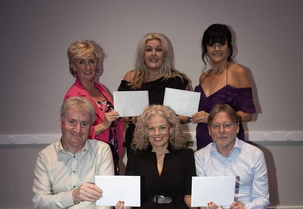 ST. JOSEPH'S RETIREMENTS. . . . .Mrs. Ciara Deane, principal and Mrs. Fiona Harrigan (both centre) making presentations to St. Joseph's Boys School teachers who are stepping down this year after over 30 years each of service to the School. At front is. Mr. Paul Kealey, Vice Principal and Mr. Terry O'Brien, and back Ms. Caroline Barnett and Mrs. Margaret Ross. (Photos: Jim McCafferty Photography)