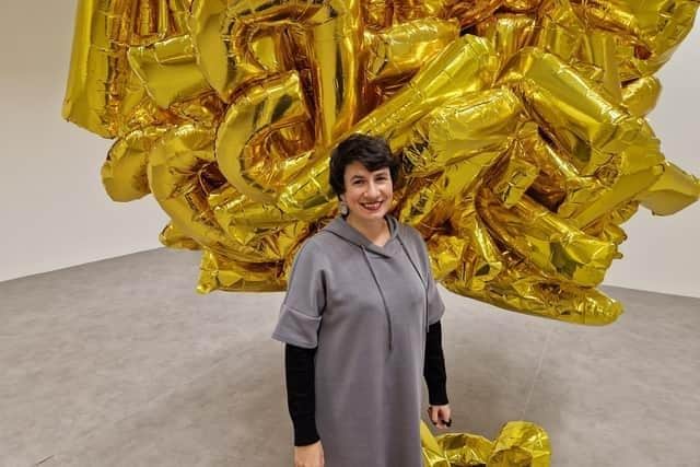 Void director Viviana Checchia with Istanbul-based artist Banu Cennetoğlu's 'right?' installation in 2023. The work presents the articles of the Universal Declaration of Human Rights in bouquets of gold letter balloons.