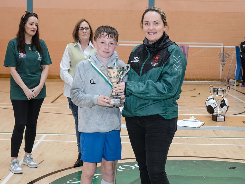 Sacred Heart PS captain Cian Lynch collecting the Sean O'Kane Plate Trophy from Ciara McGlynn on Friday at St. Joseph's Boys School.