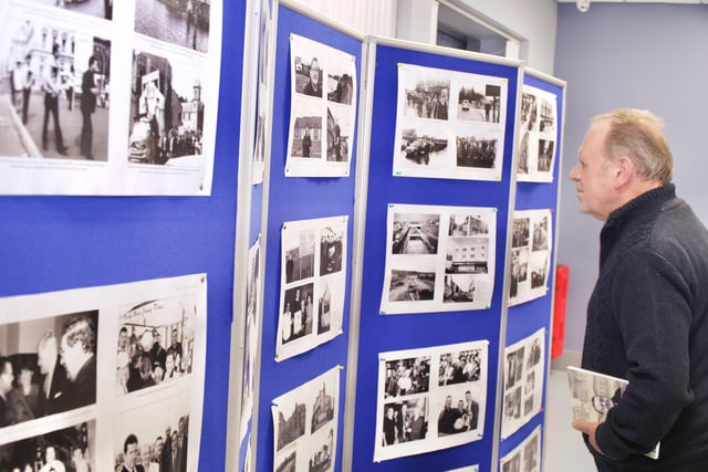 Billy Page viewing old photographs at the launch of Tony Hassan's new memoir 'From Old Streets to New Homes'.