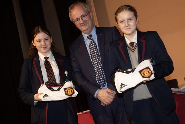 Mr. John Harkin, Principal, Oakgrove Integrated College, pictured with Manchester United Foundation prizewinners Ellen and Claragh.