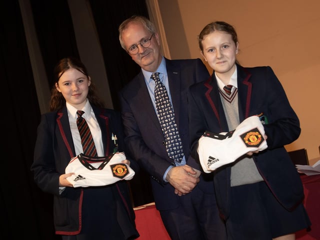 Mr. John Harkin, Principal, Oakgrove Integrated College, pictured with Manchester United Foundation prizewinners Ellen and Claragh.