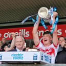 Derry minor captain James Sargent lifts the Fr. Murray Cup after defeating Armagh in Healy Park on Sunday.