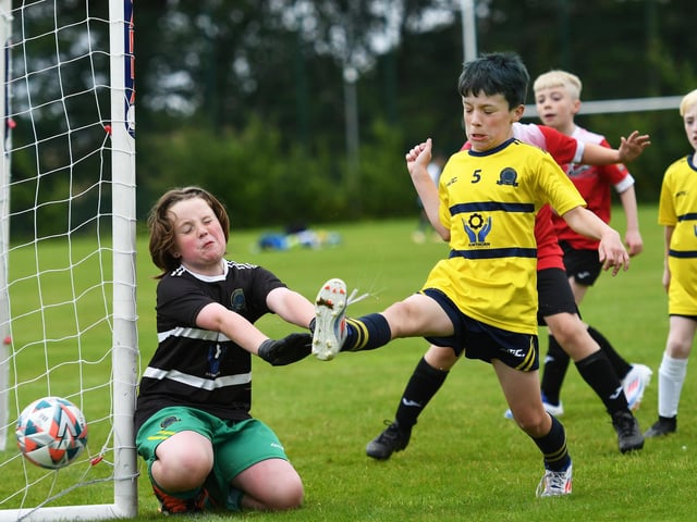 Don Boscos Juniors under-10's defender George Walker diverts this ball wide of the post during their match against Maiden City at Oakgrove. (Photo: Keith Moore)