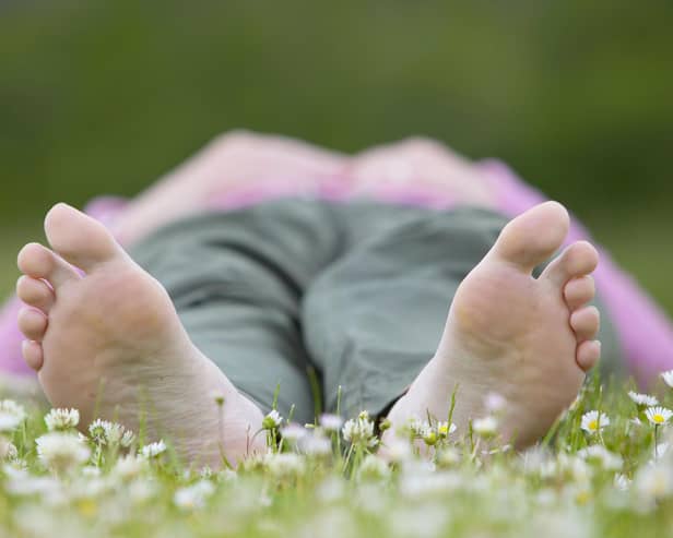 Woman enjoying nature on a summer day in a field of daisies. © Pete Cairns / naturepl.com / WWF