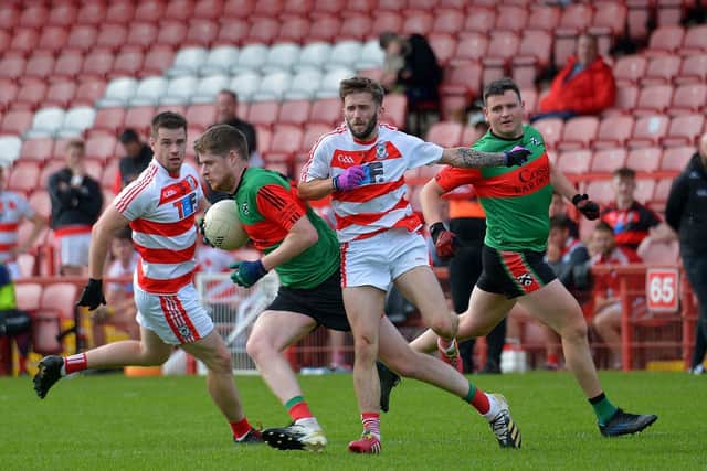 Doire Trasna’s Tom Casey evades a challenge from Ballerin pair Anton Bradley and Shane Ferris during the JFC Semi Final in Celtic Park on Sunday afternoon last. Photo: George Sweeney. DER2240GS – 007