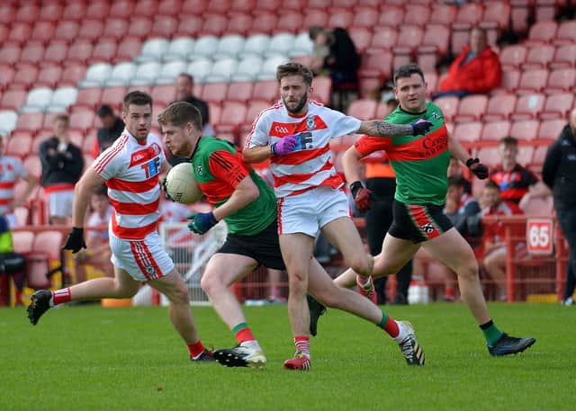 Doire Trasna’s Tom Casey evades a challenge from Ballerin pair Anton Bradley and Shane Ferris during the JFC Semi Final in Celtic Park on Sunday afternoon last. Photo: George Sweeney.  DER2240GS – 007