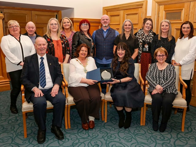 The Mayor of Derry, Councillor Patricia Logue, presenting a civic gift to Sharon McCormick at a reception in the Guildhall in appreciation of her contribution to improving peoples lives in the City and District. Included are family and friends who attended the event.