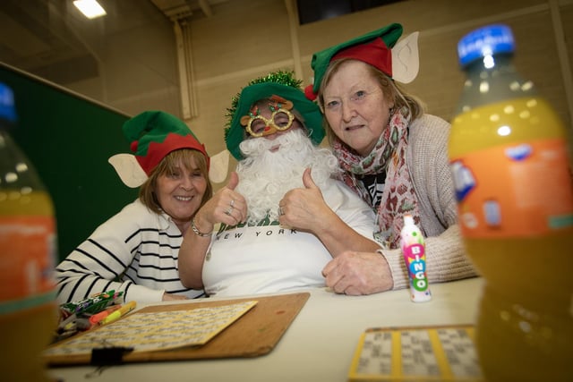 IN THE CHRISTMAS SPIRIT. . . .Doreen Travers, Ann O'Donnell and Lyn O'Connell get into the festive mood at Wednesday's OLT Christmas Bingo. : .