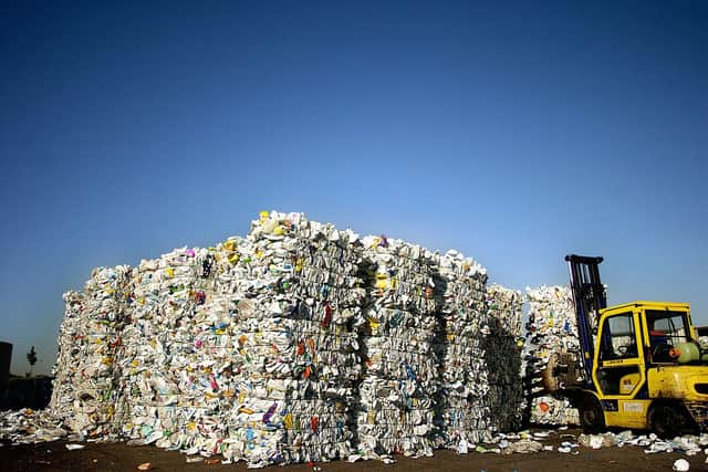 An employee discharges plastic milk bottles coming from a household waste processing plant n La Loyere, central France. The bottles were to be transformed into pellets to make plastic duct tubes. (Photo by JEFF PACHOUD/AFP via Getty Images)
AFP PHOTO JEFF PACHOUD (Photo by JEFF PACHOUD / AFP) (Photo by JEFF PACHOUD/AFP via Getty Images)